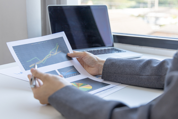 A Business Consultant Looking At Stats