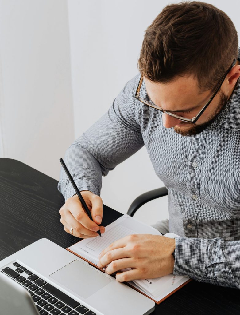 A Payroll Administrator Working At His Desk