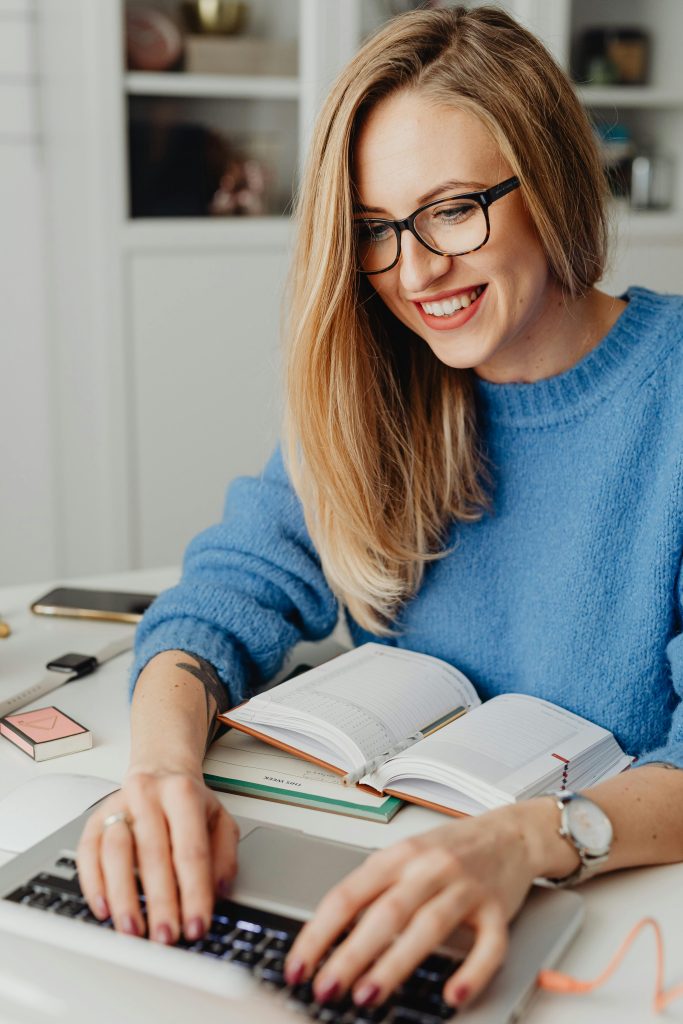 Blond Community Manager Working In Blue Jumper
